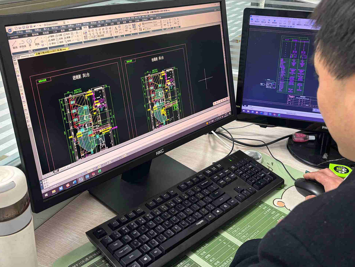 Wondon Electric Engineer Reviewing CAD Electrical Drawings At Workstation