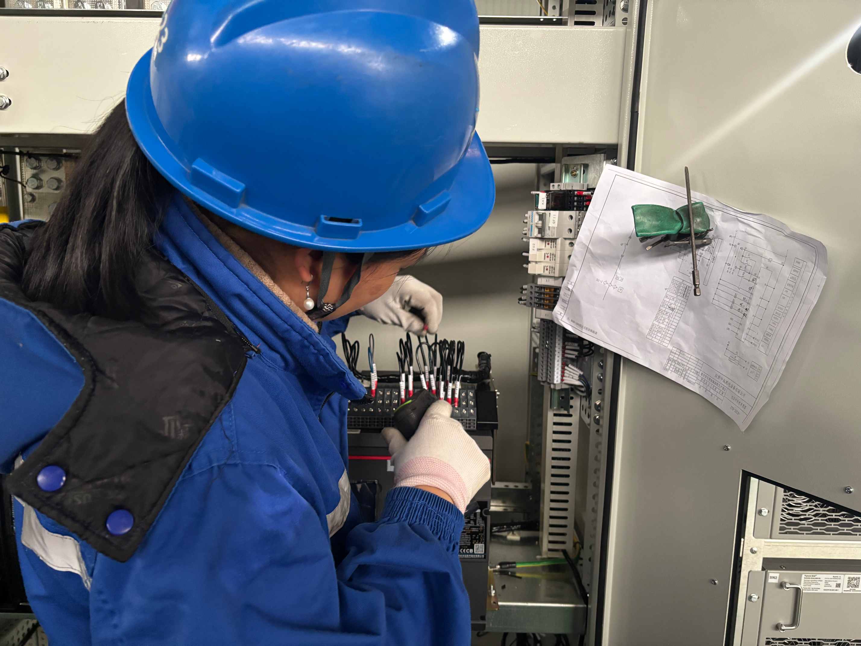 worker assembling the electrical control panel