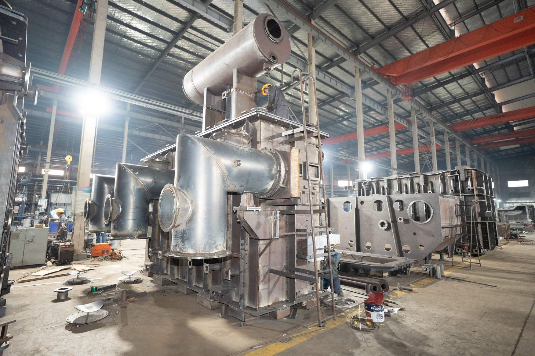 workers assembling large power transformer